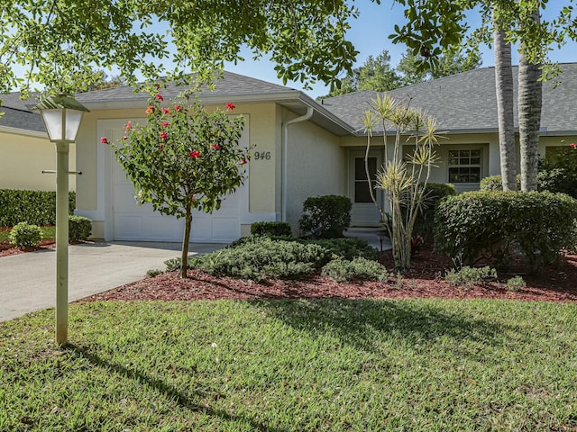 ranch-style home featuring a front yard, roof with shingles, stucco siding, a garage, and driveway