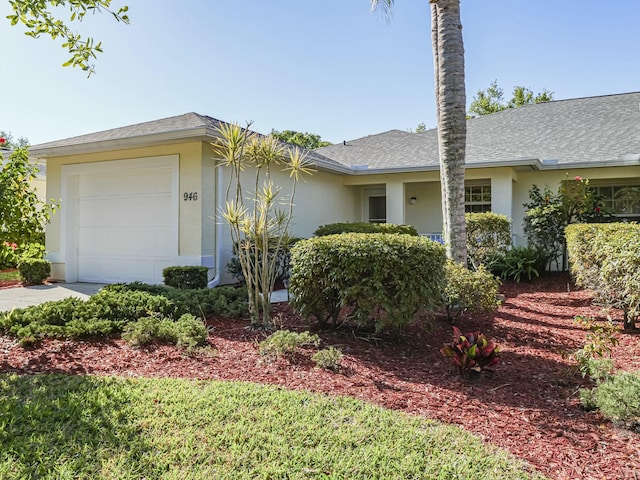 view of home's exterior featuring a garage, a shingled roof, driveway, and stucco siding