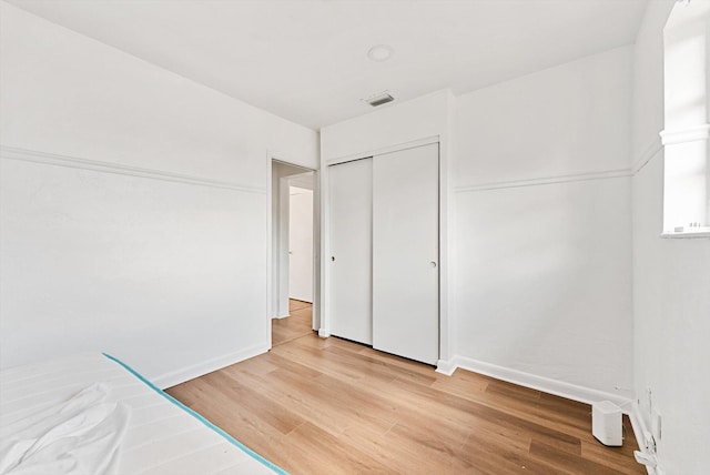 6560 Hayes St, Hollywood, FL 33024 - unfurnished bedroom with a closet, baseboards, visible vents, and light wood finished floors