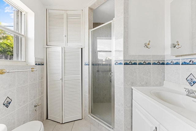 6560 Hayes St, Hollywood, FL 33024 - bathroom featuring a stall shower, tile walls, tile patterned floors, vanity, and a closet