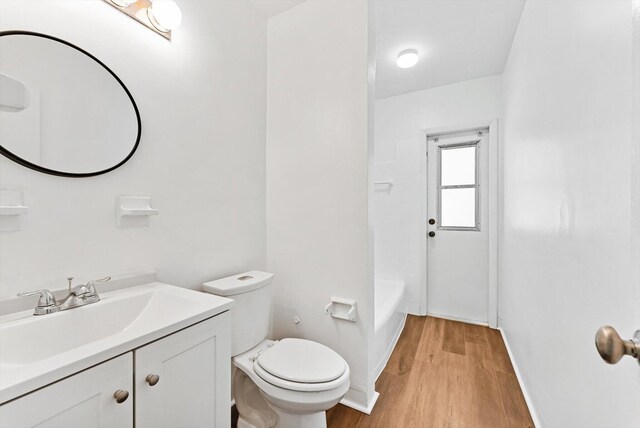 6560 Hayes St, Hollywood, FL 33024 - bathroom with baseboards, vanity, toilet, and wood finished floors