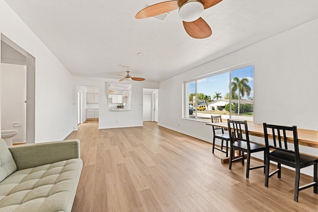 6560 Hayes St, Hollywood, FL 33024 - living area featuring a ceiling fan, baseboards, light wood-style flooring, and a textured ceiling