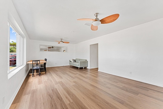 6560 Hayes St, Hollywood, FL 33024 - living area with ceiling fan, baseboards, visible vents, and light wood-style floors