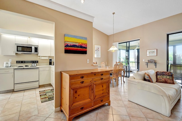 kitchen with white electric range, stainless steel microwave, white cabinetry, and a healthy amount of sunlight