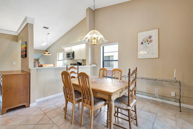 dining area featuring a wealth of natural light, visible vents, lofted ceiling, and baseboards