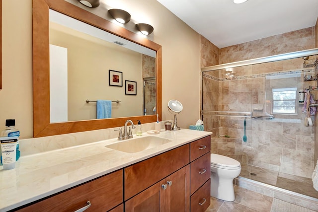 bathroom with toilet, a shower stall, visible vents, and vanity