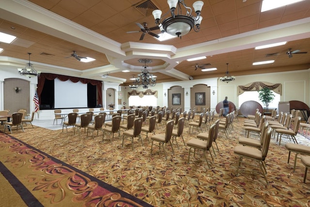 home theater room with ceiling fan with notable chandelier, ornamental molding, carpet flooring, and arched walkways