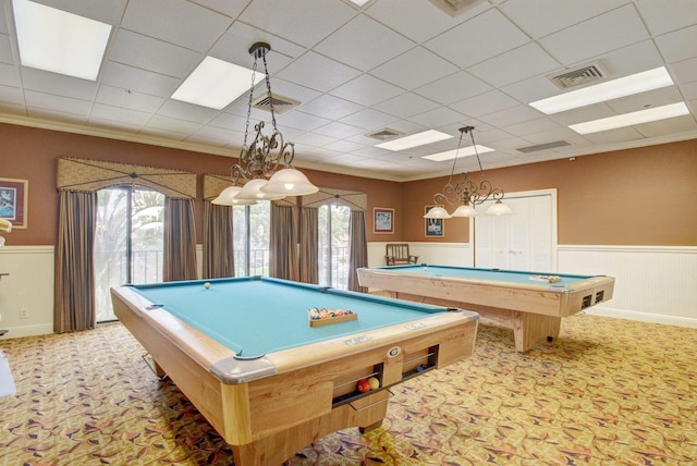 rec room with carpet floors, wainscoting, visible vents, and crown molding