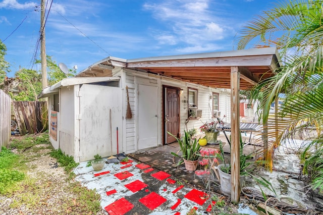 view of outbuilding featuring fence