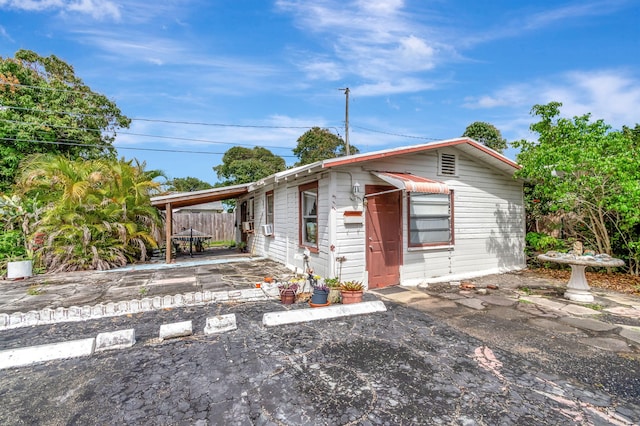 view of front of house featuring a patio area and fence