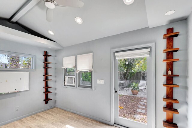 doorway with lofted ceiling with beams, recessed lighting, a wealth of natural light, and light wood-style floors