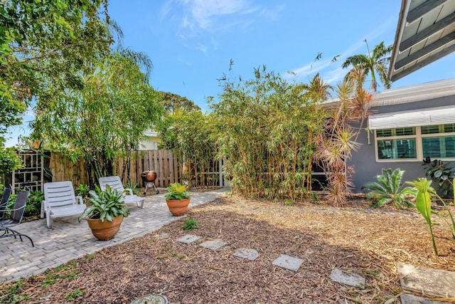 view of yard with fence and a patio