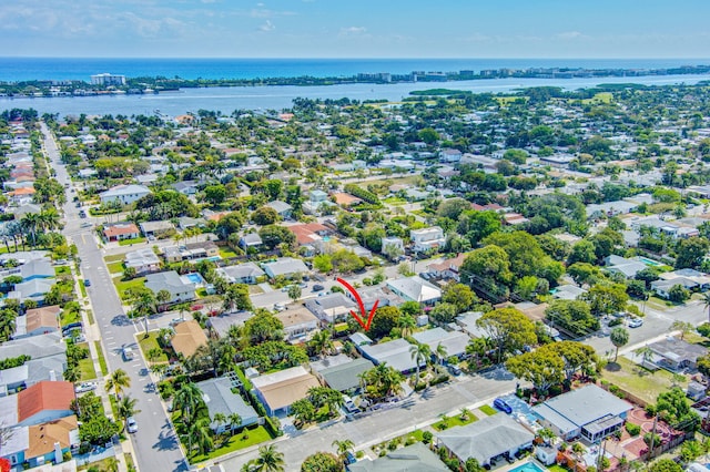 birds eye view of property with a water view and a residential view