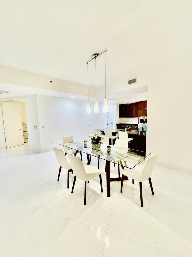 dining area with light tile patterned floors, stairs, and visible vents