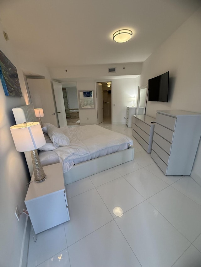 bedroom featuring visible vents and light tile patterned floors