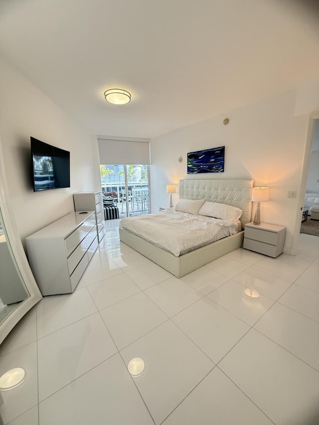 bedroom featuring access to exterior and tile patterned flooring