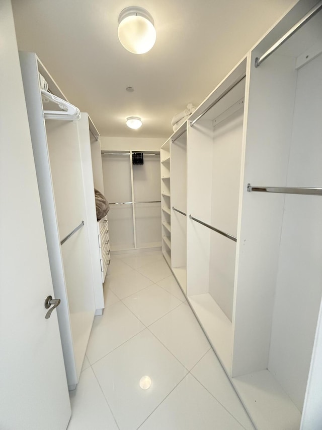 spacious closet with light tile patterned floors