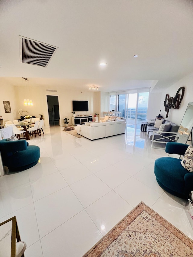 tiled living room featuring recessed lighting and visible vents