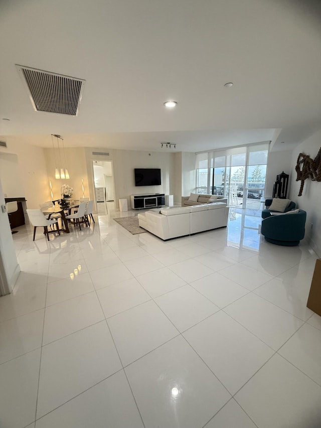 tiled living area with recessed lighting and visible vents