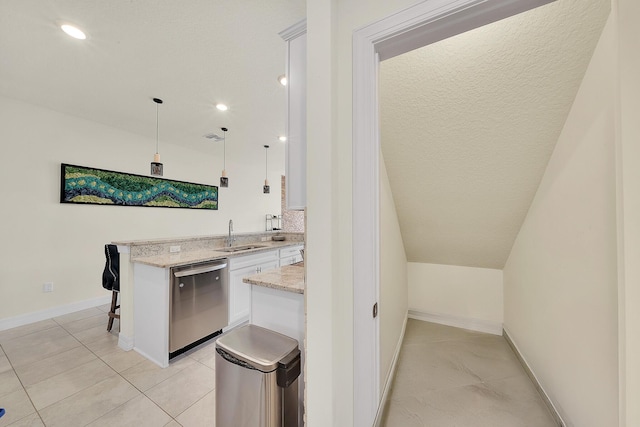 kitchen with a sink, light stone counters, white cabinets, dishwasher, and hanging light fixtures