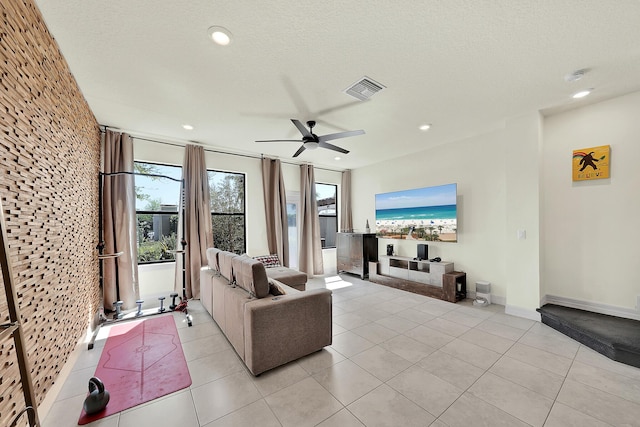 living area featuring light tile patterned floors, recessed lighting, and visible vents