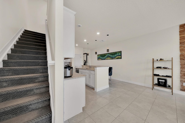 stairway with tile patterned floors, baseboards, and recessed lighting