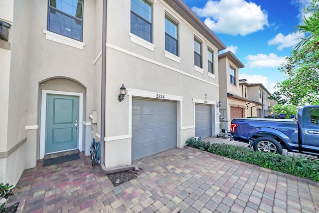 view of front facade with an attached garage and stucco siding