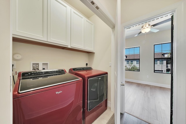 laundry area with baseboards, ceiling fan, light wood-type flooring, cabinet space, and independent washer and dryer