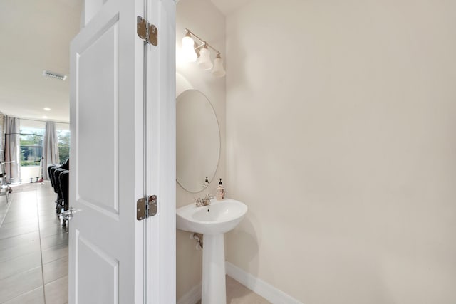 bathroom featuring visible vents, baseboards, and tile patterned flooring