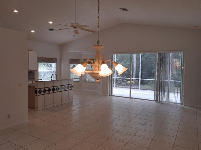 unfurnished room with light tile patterned floors, visible vents, and a healthy amount of sunlight