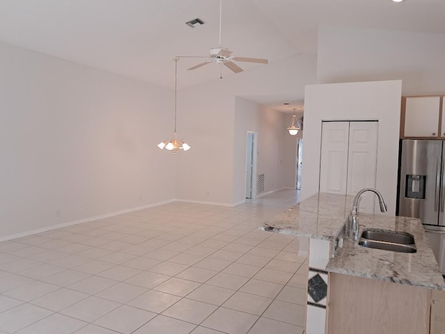 kitchen with stainless steel fridge, baseboards, visible vents, a ceiling fan, and a sink