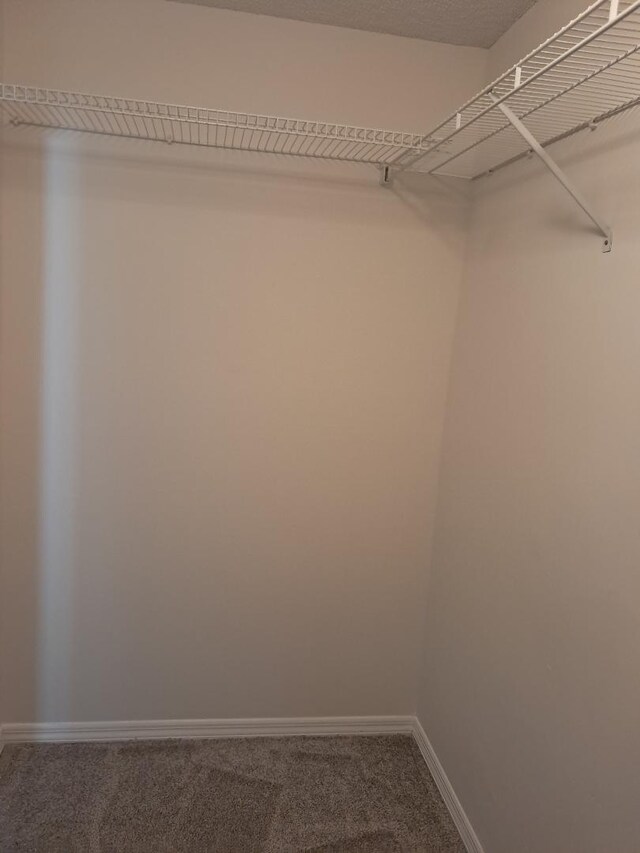 bathroom featuring a wainscoted wall, tile walls, toilet, vanity, and tile patterned flooring