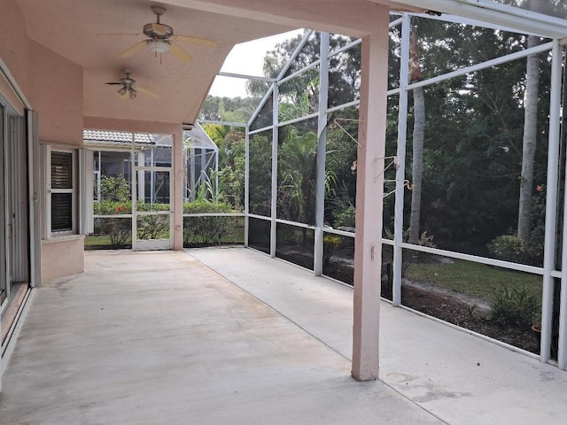 unfurnished sunroom with ceiling fan