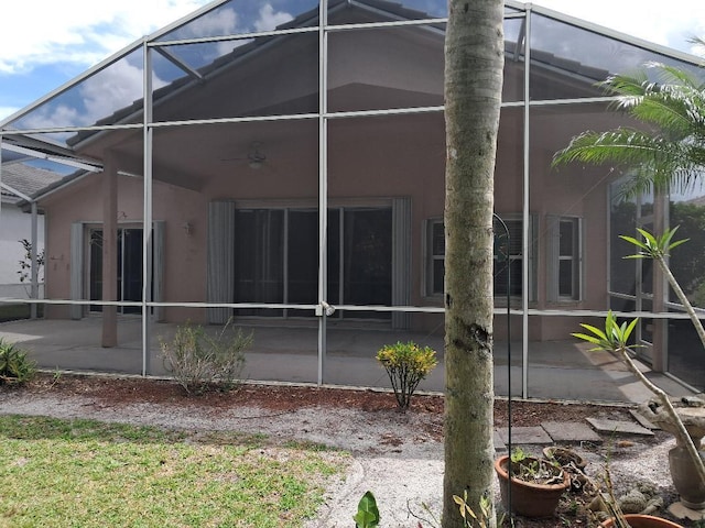 7260 SE Magellan Ln, Stuart, FL 34997 - back of property featuring a lanai, a patio, a ceiling fan, and stucco siding
