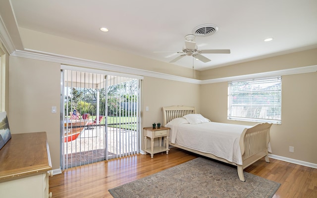 bedroom with access to outside, visible vents, and wood finished floors