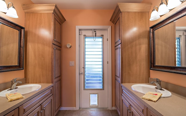 bathroom featuring two vanities, a sink, and tile patterned floors