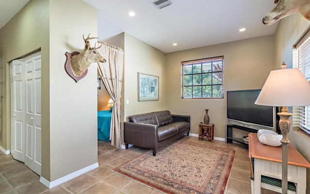 interior space featuring tile patterned flooring, visible vents, baseboards, and recessed lighting