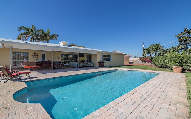 view of pool with a fenced in pool, a patio area, fence, and an outdoor living space