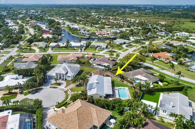 drone / aerial view with a water view and a residential view