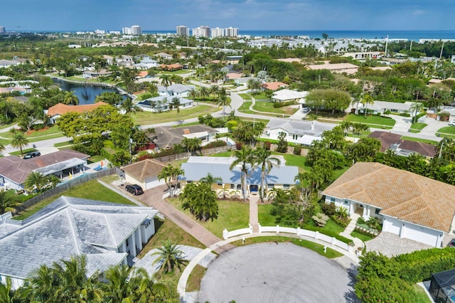 drone / aerial view with a water view and a residential view