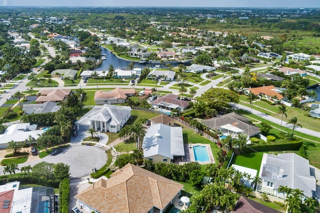 drone / aerial view featuring a water view and a residential view