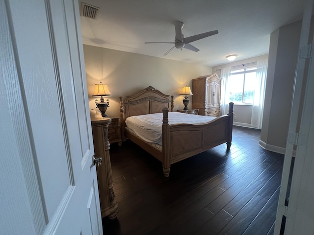 bedroom featuring dark wood-style floors, ceiling fan, visible vents, and baseboards