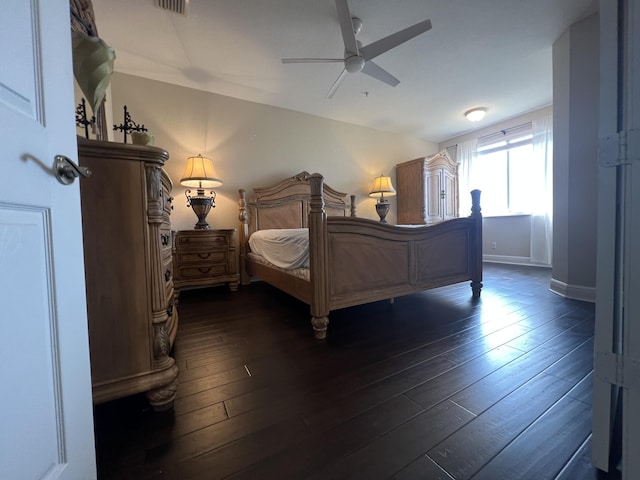 bedroom featuring dark wood-style floors, ceiling fan, and baseboards