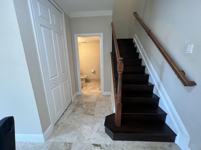 stairway with marble finish floor and baseboards