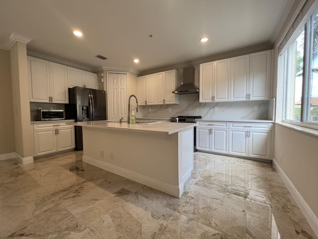 kitchen featuring marble finish floor, wall chimney exhaust hood, white cabinets, and black fridge with ice dispenser