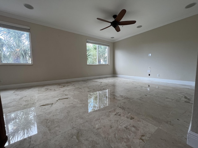 empty room featuring marble finish floor, baseboards, and crown molding