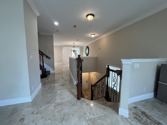 hallway featuring crown molding, an upstairs landing, baseboards, marble finish floor, and an inviting chandelier