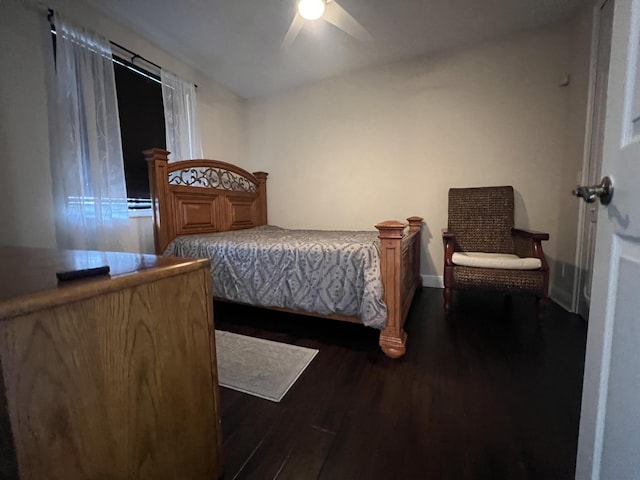 bedroom with a ceiling fan, dark wood finished floors, and baseboards