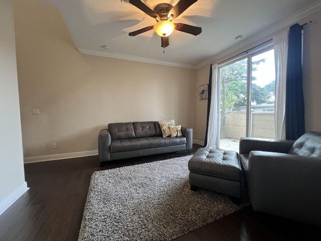 living area with crown molding, ceiling fan, dark wood-type flooring, and baseboards