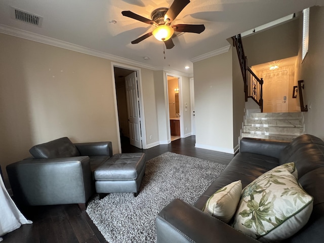 living area with crown molding, visible vents, dark wood finished floors, and stairs